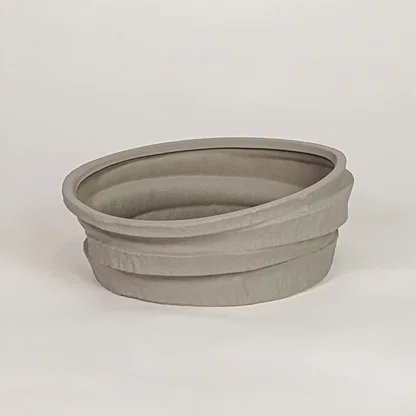 Grey ceramic decorative bowl with layered textured design for modern tabletop shelf and console decor placement.