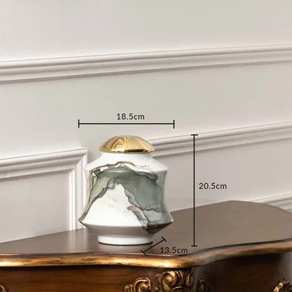 White ceramic jar with gray abstract swirl and gold lid shown with dimensions 20.5 cm height and 18.5 cm width.