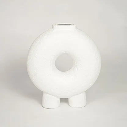 Contemporary white ceramic decorative vase with circular cutout perfect for entryway table living room or dining decor display.
