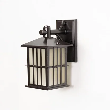 Black metal outdoor wall lantern switched off on white background emphasizing clean structure frosted glass and wall mount style.