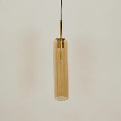 Amber glass pendant light with brass accents adding modern elegance to kitchen ceiling placement.