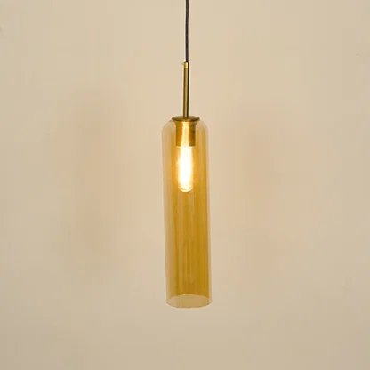 Amber glass pendant light illuminated with warm glow for stylish dining room ceiling decor.