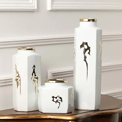 Set of white ceramic decorative vases with seahorse artwork for elegant shelf styling and contemporary home decor.