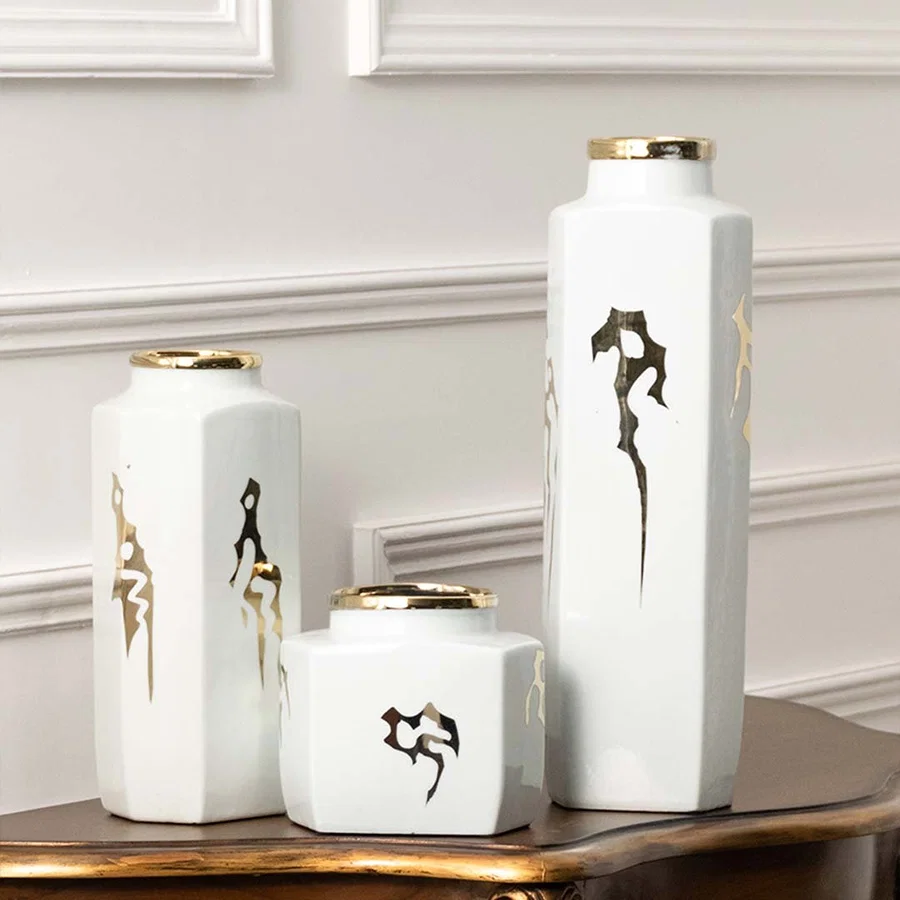 Set of white ceramic decorative vases with seahorse artwork for elegant shelf styling and contemporary home decor.