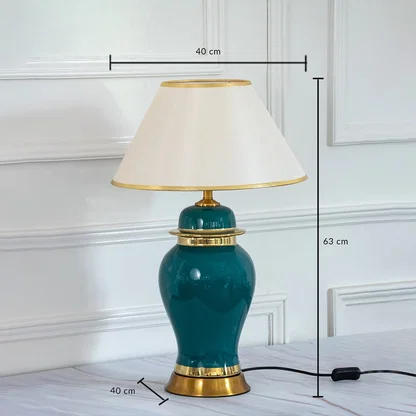 Green ceramic table lamp with golden base and shade showing 63 cm height and 40 cm width dimensions.