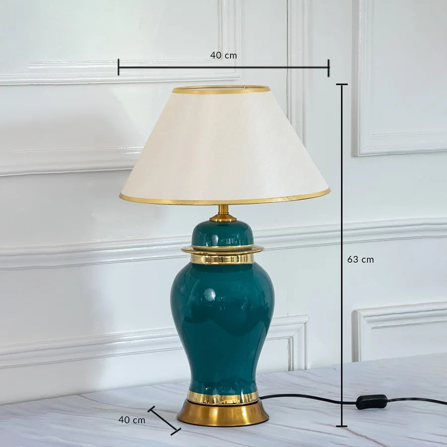 Green ceramic table lamp with golden base and shade showing 63 cm height and 40 cm width dimensions.