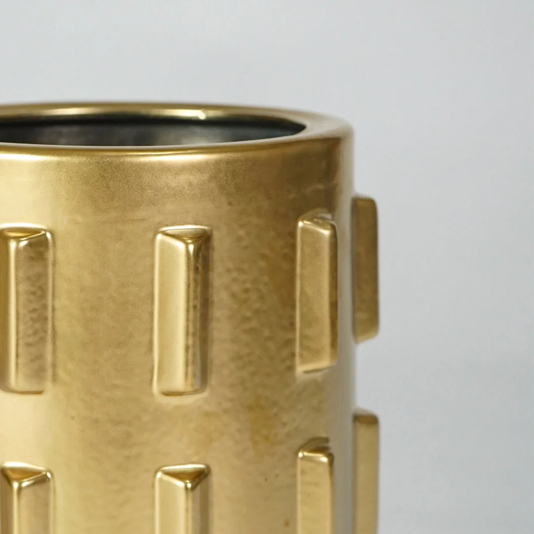 Closeup image of gold metal decor vase for luxury console table styling with modern textured finish display.
