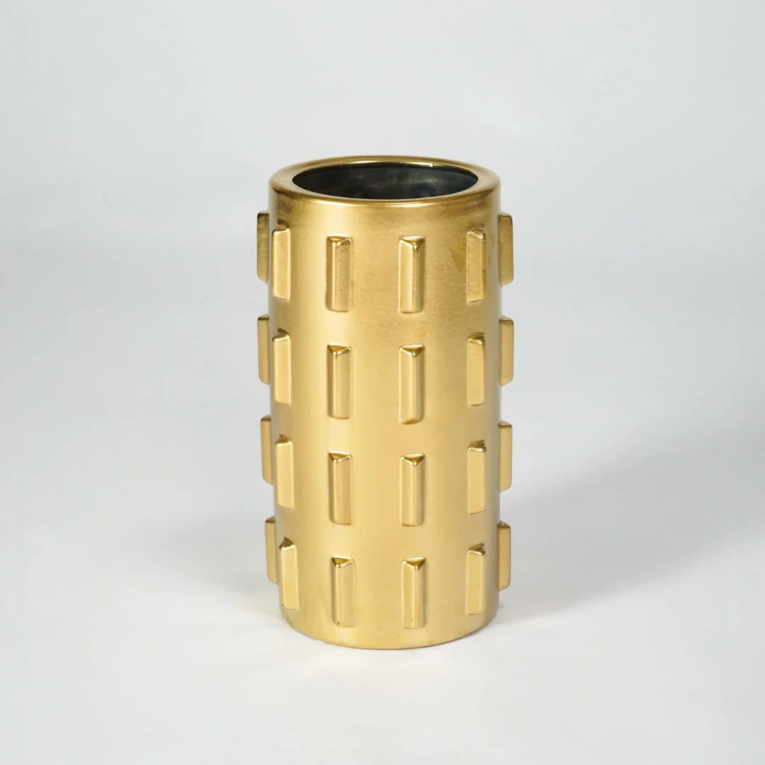 Gold metal planter pot for luxury coffee table placement and modern indoor decor styling accent display piece.