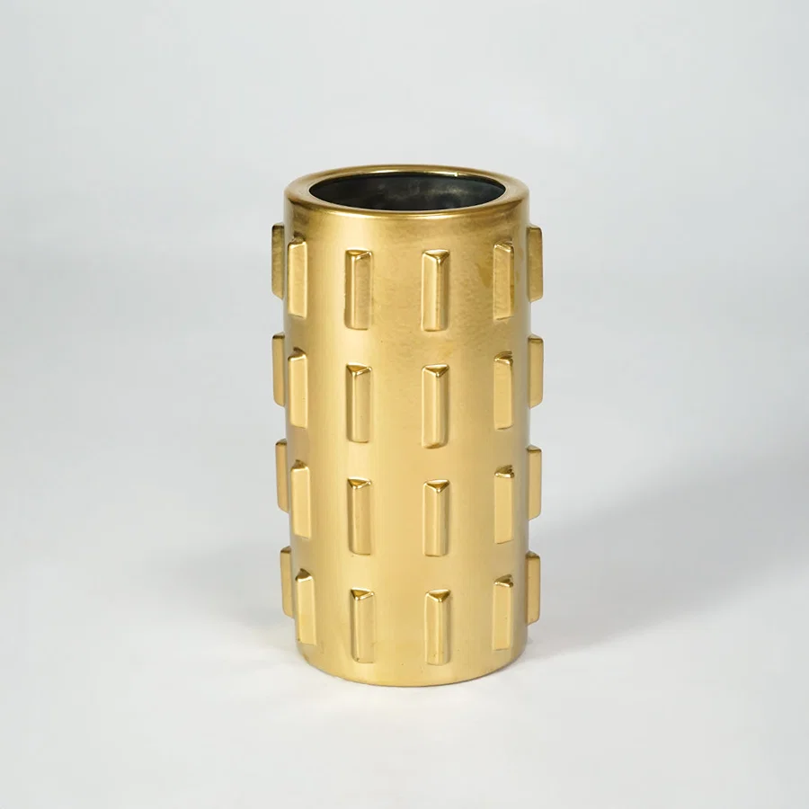 Gold metal planter pot for luxury coffee table placement and modern indoor decor styling accent display piece.