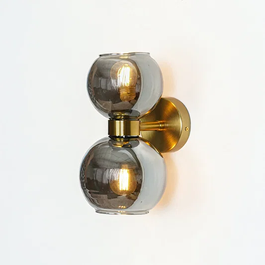 Double smoked glass globe wall light with gold base modern wall lamp for bedroom living room decor warm ambient lighting.