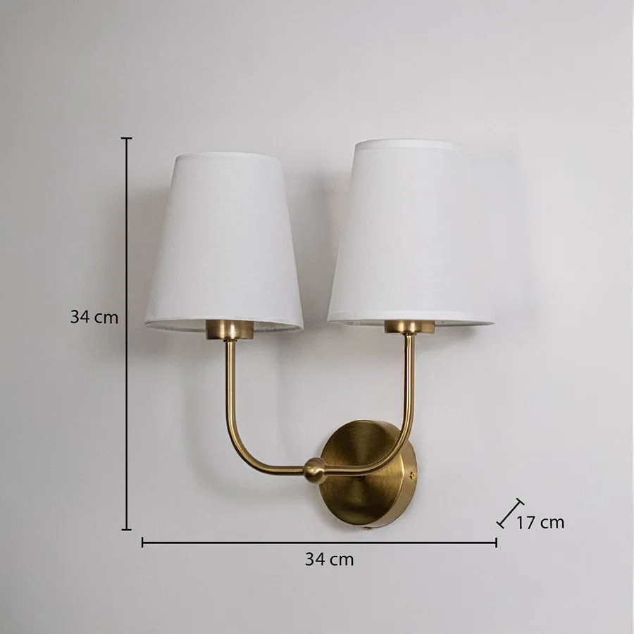 Gold metal double wall sconce with white shades shown with 34 cm height and 34 cm width for accurate size detail.