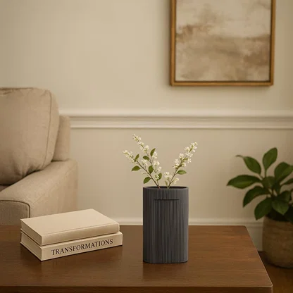 Dark grey textured ceramic vase with vertical ribbed pattern styled as modern table decor accent for contemporary living interiors.