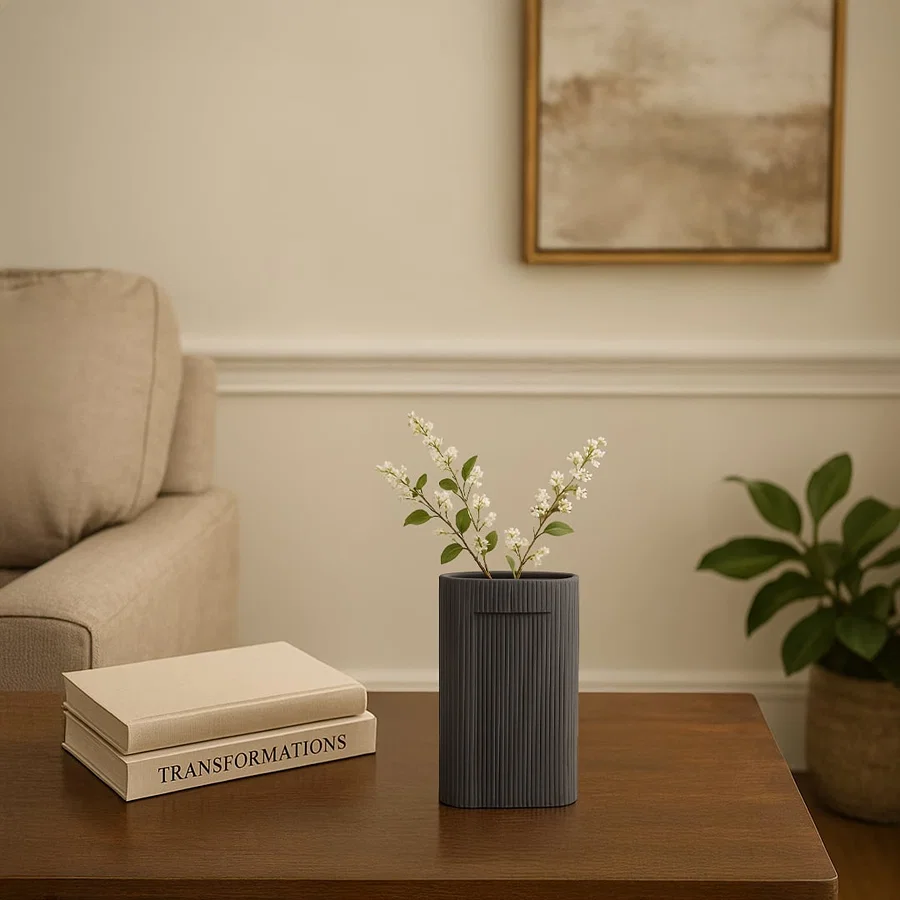 Dark grey textured ceramic vase with vertical ribbed pattern styled as modern table decor accent for contemporary living interiors.