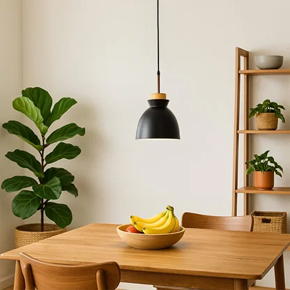Black metal pendant light above dining table adding Scandinavian elegance and warm ambient lighting to modern interiors.