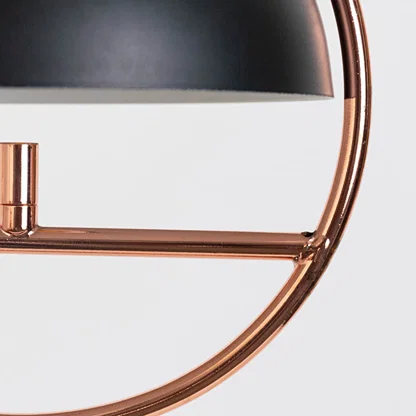 Closeup of black metal and copper pendant light highlighting sleek curves and premium craftsmanship.