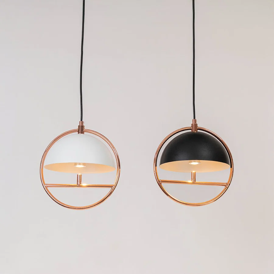 Set of black and white metal pendant lights with copper finish for stylish contemporary interiors.
