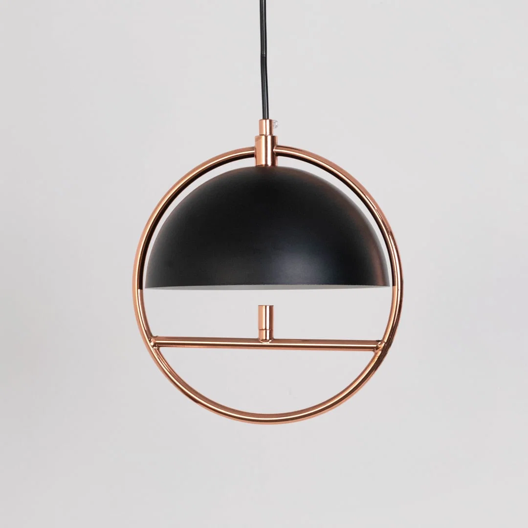 Black metal and copper pendant light with dome shade designed for modern dining room and living room decor.