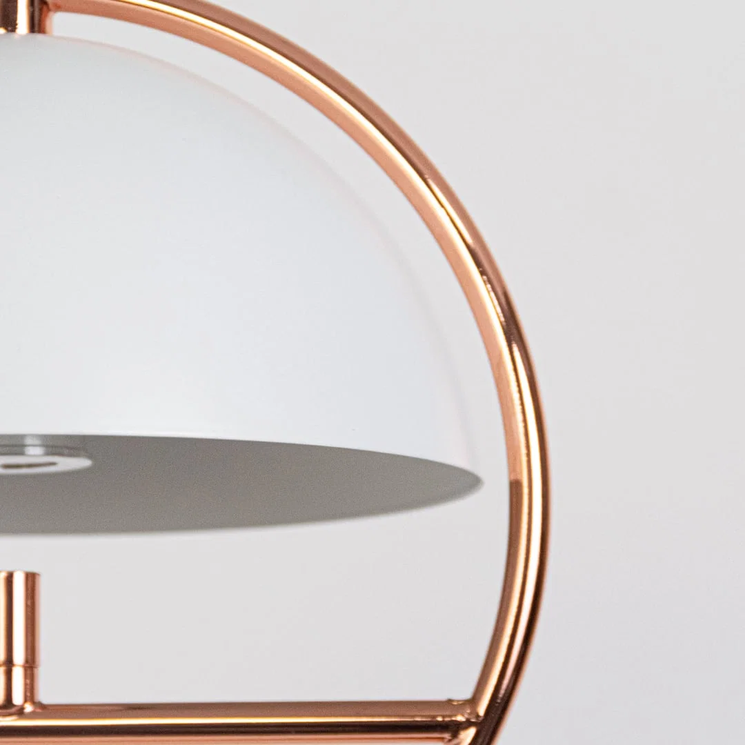Closeup of black metal and copper pendant light highlighting refined curves and premium craftsmanship.