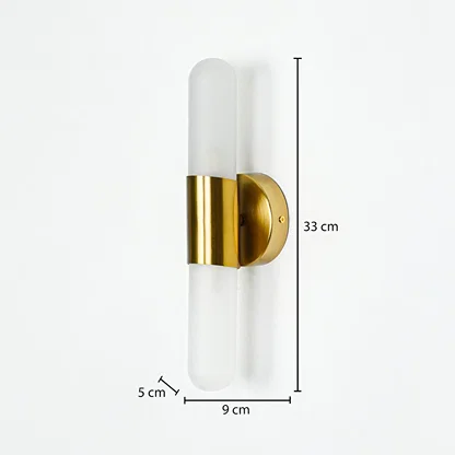 Modern wall light with frosted cylindrical glass and gold metal base mounted on neutral wall background 33 cm height 9 cm width 5 cm depth ideal for contemporary interior lighting.