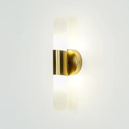 Gold wall light with vertical frosted glass tube mounted on neutral wall background ideal for modern bedroom or hallway lighting.