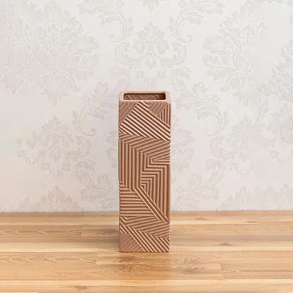 A tall brown geometric vase on a clean white background showing its bold textured pattern and modern sculptural design for home decor.