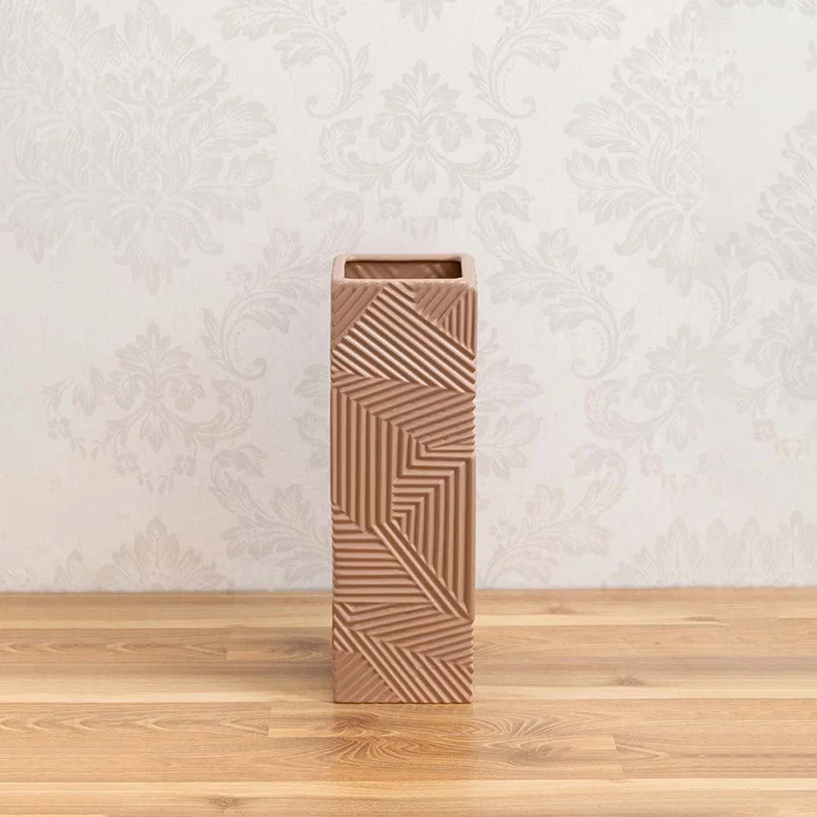 A tall brown geometric vase on a clean white background showing its bold textured pattern and modern sculptural design for home decor.