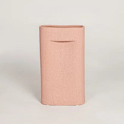 Contemporary peach ceramic flower vase with minimalist sculpted design perfect for entryway table living room decor display.