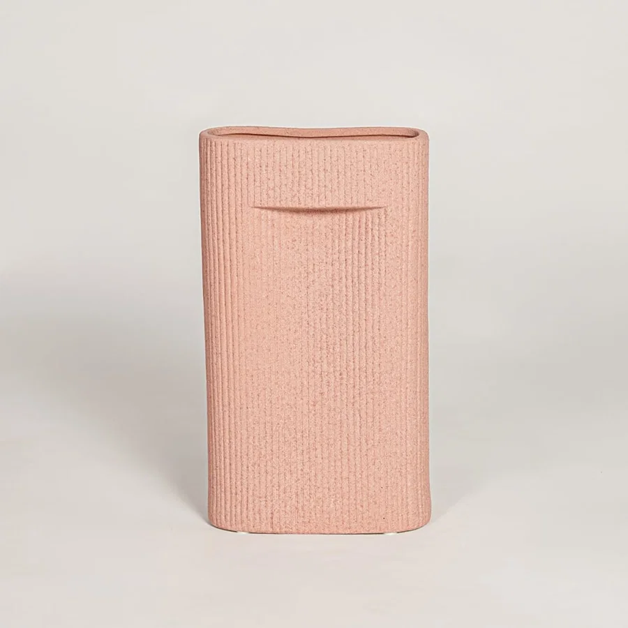 Contemporary peach ceramic flower vase with minimalist sculpted design perfect for entryway table living room decor display.