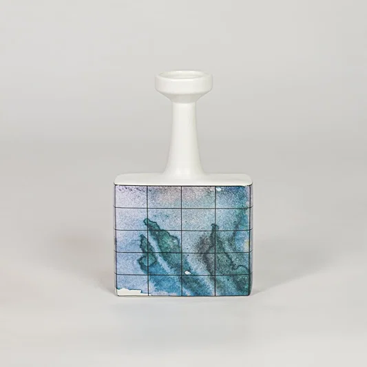 Blue glass bottle vase for stylish console table placement and contemporary indoor decor styling accent piece.