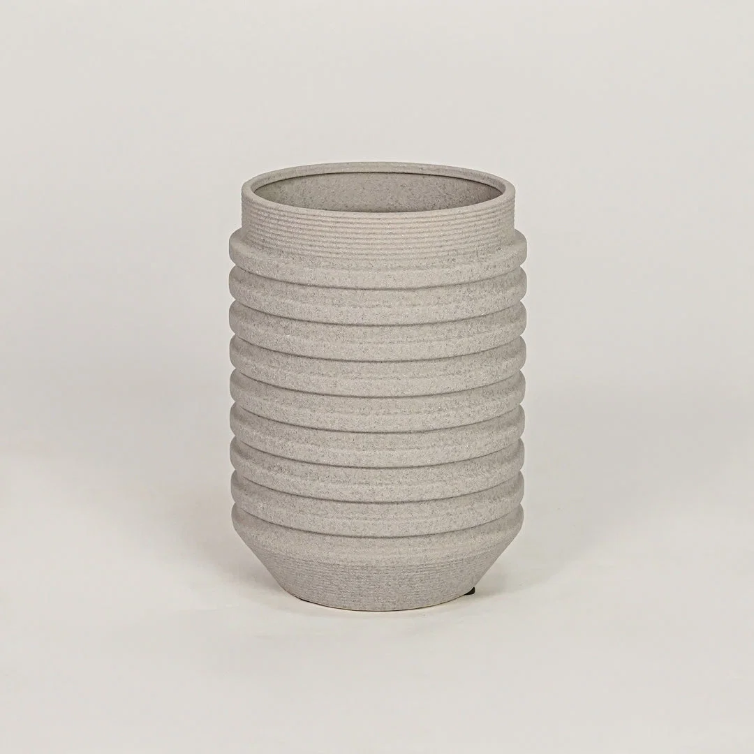 Textured grey ribbed cylindrical vase for minimalist home decor and contemporary interior table styling accents.