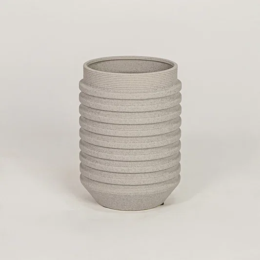 Textured grey ribbed cylindrical vase for minimalist home decor and contemporary interior table styling accents.