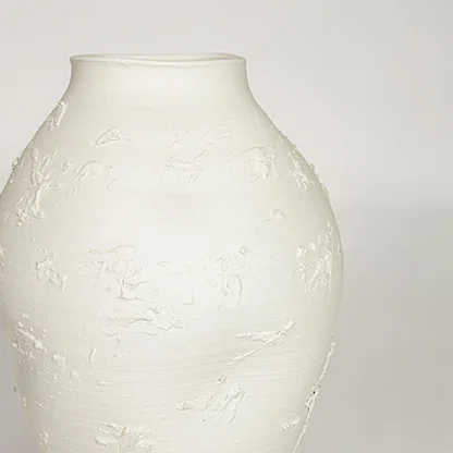 White ceramic textured decorative vase with artistic sculpted surface perfect for elegant dried floral display and modern interior decor.
