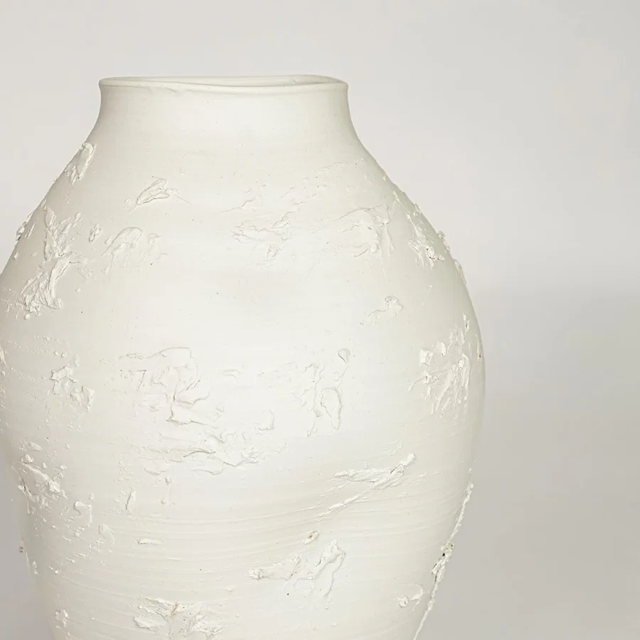 White ceramic textured decorative vase with artistic sculpted surface perfect for elegant dried floral display and modern interior decor.