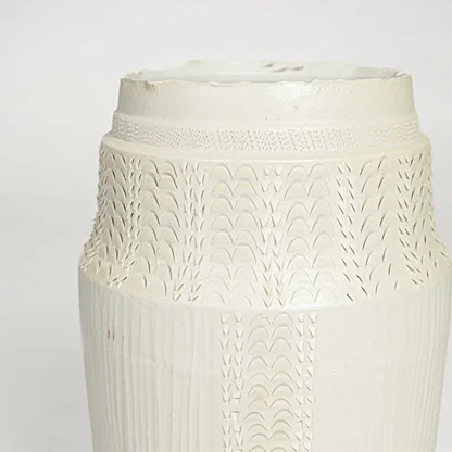 Close view of white ceramic textured vase featuring intricate surface pattern and elegant handcrafted detailing.
