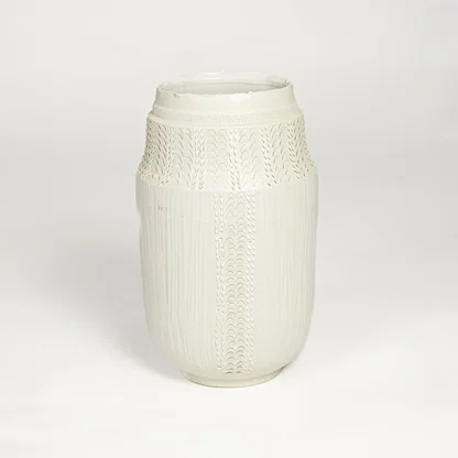 White ceramic textured vase with detailed handcrafted pattern isolated on clean white background for contemporary home decor use.
