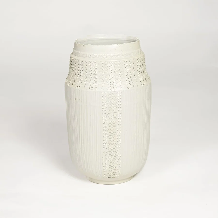 White ceramic textured vase with detailed handcrafted pattern isolated on clean white background for contemporary home decor use.