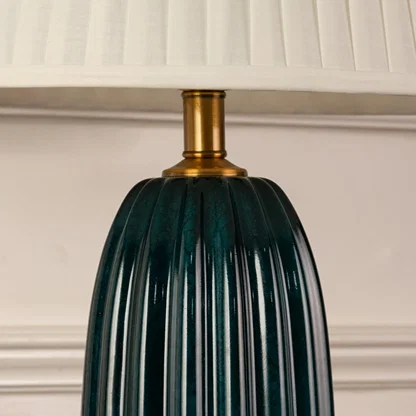 Blue ribbed glass lamp base with brass detailing showcasing refined craftsmanship and sophisticated decorative appeal.