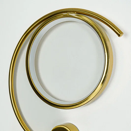 Beautiful warm illuminated gold metal led ring wall light for modern bedroom decor styling and luxury home lighting design