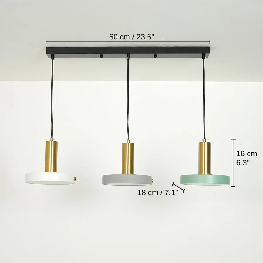 Three-light linear ceiling pendant fixture with black ceiling mount, black cords, gold cylindrical shades, and round white, gray, and mint green lamp shades. Measurement labels show, 16 x 60 x 18 cm (6.3 x 23.6 x 7.1 inches) dimensions