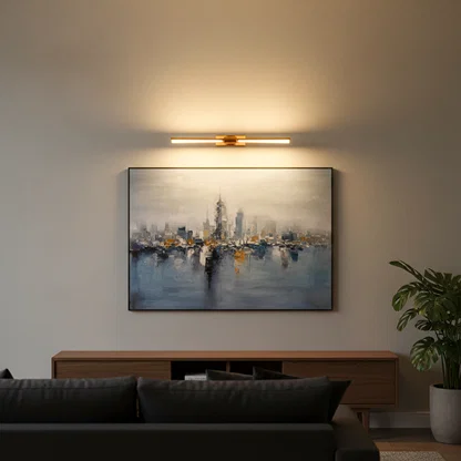 Gold metal picture light casting warm illumination above framed artwork enhancing sophisticated living room interiors.