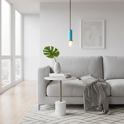 Blue metal pendant light above side table adding Scandinavian elegance and warm ambient lighting to modern interiors.