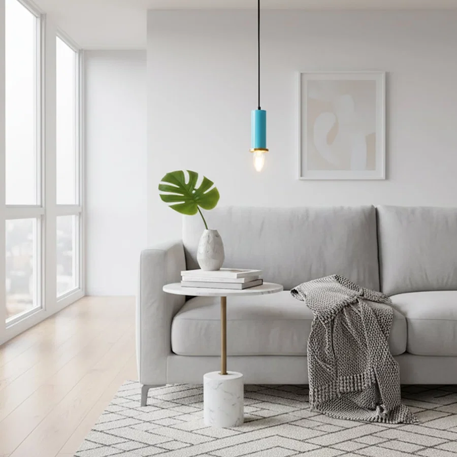 Blue metal pendant light above side table adding Scandinavian elegance and warm ambient lighting to modern interiors.