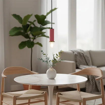 Pink metal pendant light above dining table adding soft Scandinavian charm and warm ambient lighting to modern interiors.