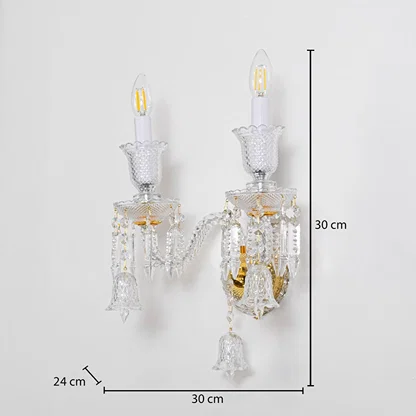 Double arm crystal wall light with gold base and crystal accents size 24cm height 30cm width 30cm depth displayed with measurements.