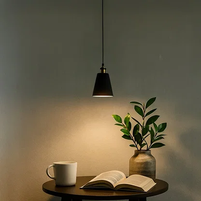 Black metal pendant light above side table creating cozy ambiance with contemporary elegance indoors.
