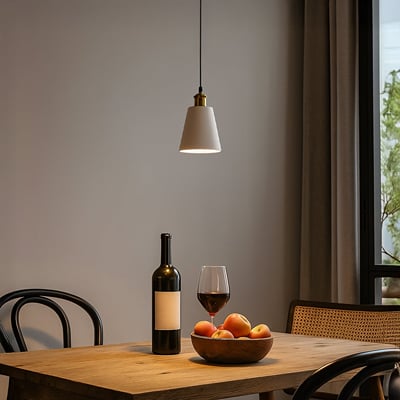 White metal pendant light with gold accents above dining table adding elegant warmth to modern interiors.