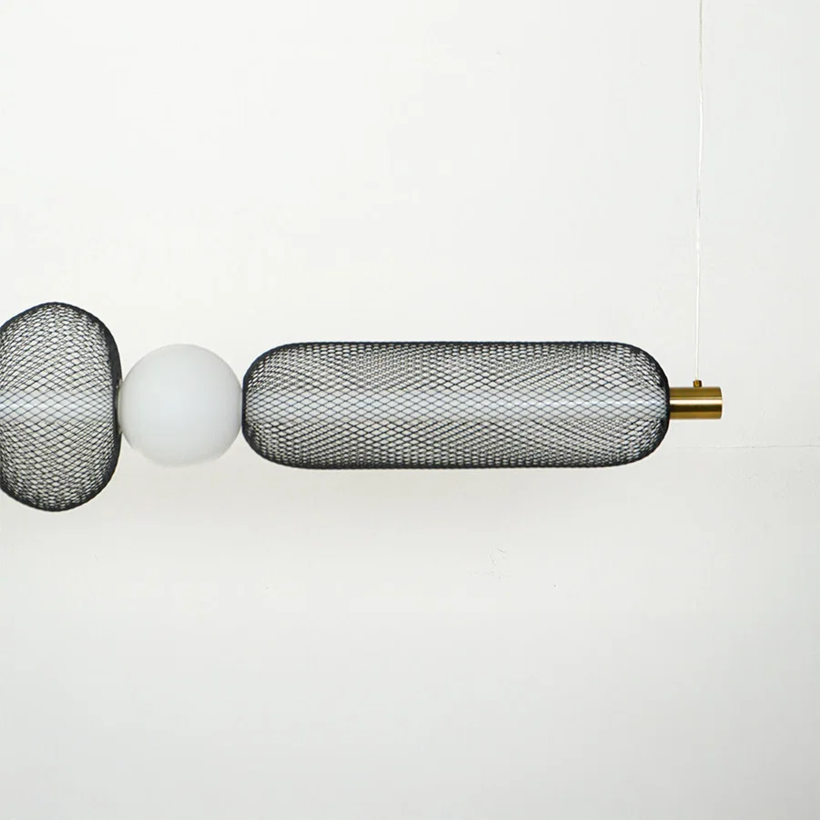 Close view of horizontal wall sconce with ribbed glass shades and metal detailing showcasing premium modern lighting design on clean background.