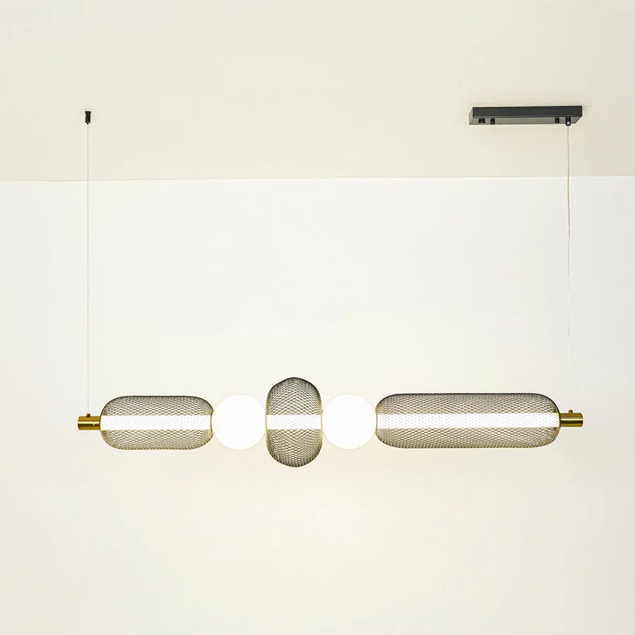 Minimal gold and white wall light with cylindrical glass shades mounted on neutral wall background ideal for modern bathroom or hallway lighting.

