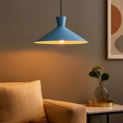Blue metal pendant light illuminating bedside area with modern ambient lighting in a stylish contemporary bedroom.