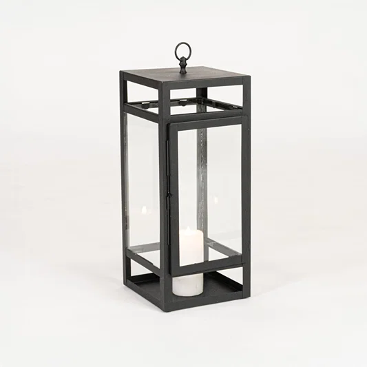 Minimal black metal candle lantern with transparent glass panels on white background perfect for home festive and patio Decor.